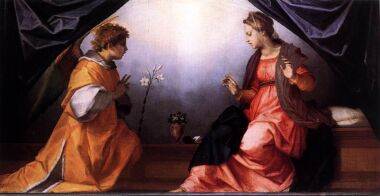 The Virgin Mary on the right in a red dress, while the angel talks to her on the left (orange outfit).
