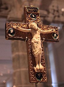 Anglo-saxon reliquary crucifix: A chocolate-colored cross with a light stone Jesus. 
