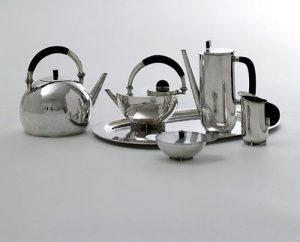 Brandt's tea infuser set with 4 pots, a bowl, and a serving platter. 