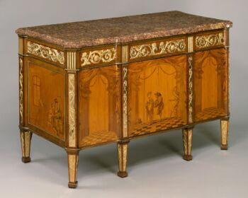 Commode à vantaux, created by Roentgen. The commode is made of light wood with inlays made out of dark woods to resemble foliage. 