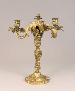 A gold candelabra with ornate flourishes. 