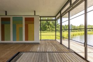 The large boathouse features walls of glass and original artwork by David Novros.