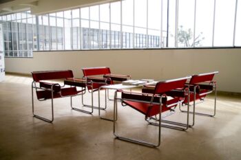 Bauhaus building by Marcel Breuer with four red Wassily Chairs (1925/26)