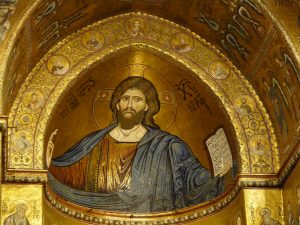 Close-up of the mosaic series in the sanctuary with Christ Pantocrator painted on the dome ceiling of the structure. He is seen in a blue robe and a stroll in hand. 