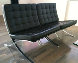 Photo of the Barcelona chair in black with silver hardware. 