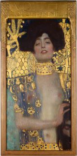 Giuditta e la testa di Oloferne. Un dipinto di una donna dai capelli scuri, con seno nudo e dettagli dorati che la circondano. 
