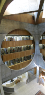 Visible structure of the library from inside the building. Exeter Library atrium with crossbeams above and circular staircase below.