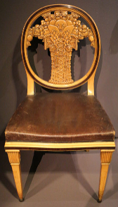 Decorative arts in the Musée d'Orsay (1912): A wood chair with an intricately carved back. 