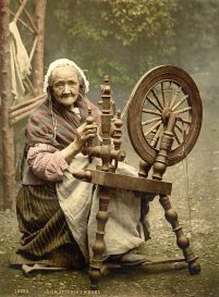 A photo of a woman with an Irish spinning wheel, dated back to the 1900s, from the Library of Congress' Collection.