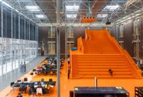 The Why Factory, el proyecto comprende una estructura naranja de tres pisos que alberga salas de conferencias, salas de reuniones e instalaciones de investigación.