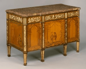 Commode à vantaux, created by Roentgen. The commode is made of light wood with inlays made out of dark woods to resemble foliage. 