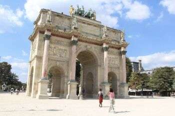 The Arc du Triomphe in Paris France, which is a light stone arch. 
