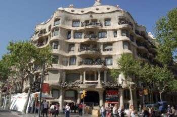 Casa Milà in Barcelona, Spain: Exterior photo of the structure, with wavy levels and balconies. 