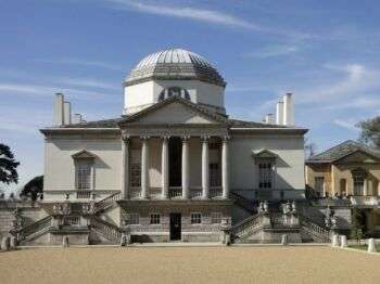 Chiswick House: A large grey building with a dome at the top and six columns along the front. 