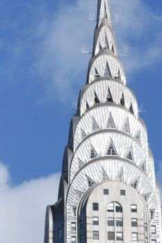 Chrysler Building - New York City @ Day: A pointy building with layered arches up until the top of the tower (thins out as each arch builds on the other). 