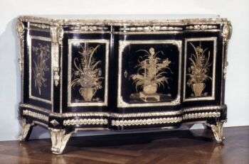 An Oak commode with Japanese black-and-gold lacquer and ebony veneer, gilt bronze, located in Paris, France.