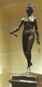A brown statue of a naked woman with a bow and arrow in her hands. 