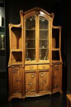 Dining room vitrine designed by Eugene Gaillard (1899-1900) in Paris: A large wooden cabinet. 