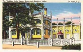 The Wedding Cake House, Kennebunk Landing, Maine: A large ornate, yellow structure with white details. 