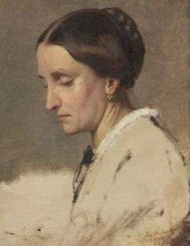Portrait of a woman with her brown hair up, in a white outfit, who is looking down with eyes closed.
