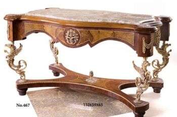 A French regency style coffee table with dragon-carvings as legs and two toned wood. 