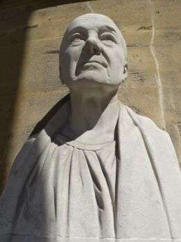 John Nash at All Souls: A statue of a bald man looking upwards. 