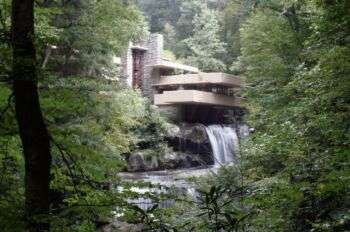 Fallingwater (Frank Lloyd Wright) house with a waterfall coming outside the bottom of the house. 