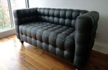 Kubus sofa: A mid-sized dark grey sofa with bubble-like cushions. 
