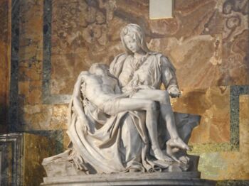 A photo of La Pietà de Michelangelo's statue in the Vatican. The Virgin Mary is depicted sorrowful and holding her son after his crucifixion.  