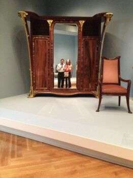 Louis Majorelle Cabinet Mirror. Two people reflected in the mirror while taking a picture of it. 