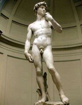 Florence - Michelangelo's 'David' statue in light stone, a naked man standing with his weight on one leg. 
