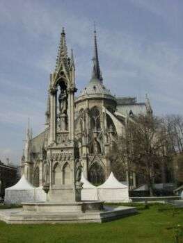 Cathedrale Notre-Dame de Paris in France. There are sharp, stone decorations that surround the structure. 