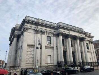 A photo of the City Hall, in Dublin, which is a large bright building with four, chunky columns along the front. 