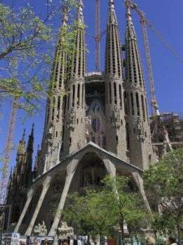 Sagrada Familia, Gaudì, 1882-1926, Barcelona: A large, sharp structure with four distinct towers. 