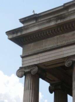 Zoomed in photo of top of capital showing off the roof of Ionic temple.